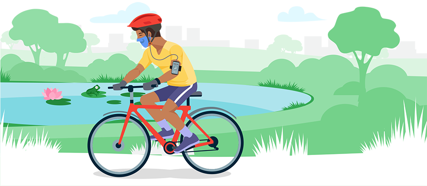 Seorang laki-laki bersepeda di taman sambil mendengarkan musik.